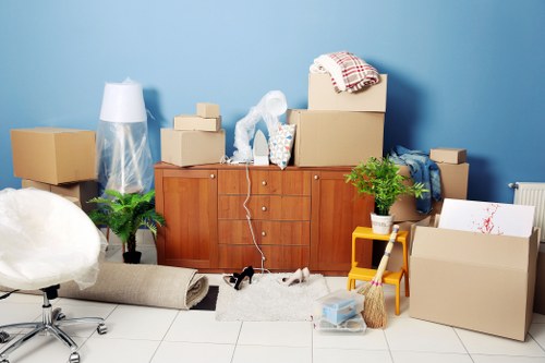 Furniture and boxes arranged to show cubic-yard pricing for removals