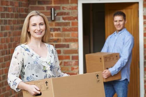 Local house removal team planning a move in Brent with a van and packed boxes
