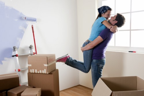 Relocation crew moving desks and furniture into a new office