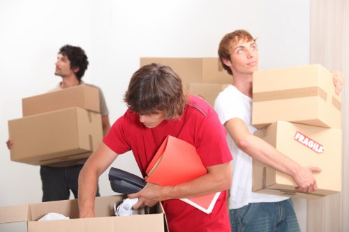 Professional movers handling furniture in a Brent flat move