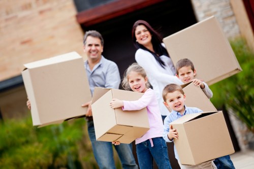 Professional movers handling furniture and boxes in Brent