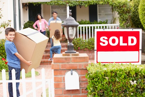 Removalists carefully loading furniture for a home move in Brent